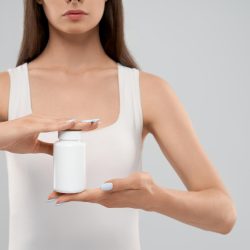 female-holding-white-container-medicine